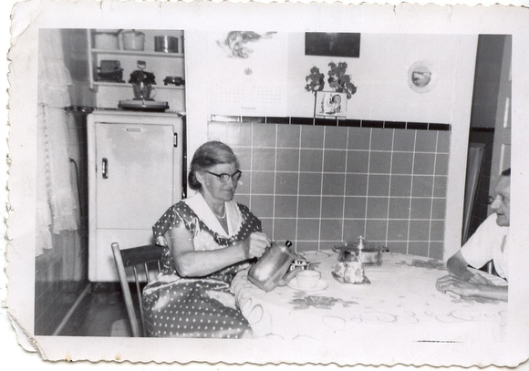 Grandma and Pop Anderson in their kitchen drinking tea